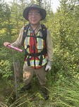 In the field, they are collecting soil samples